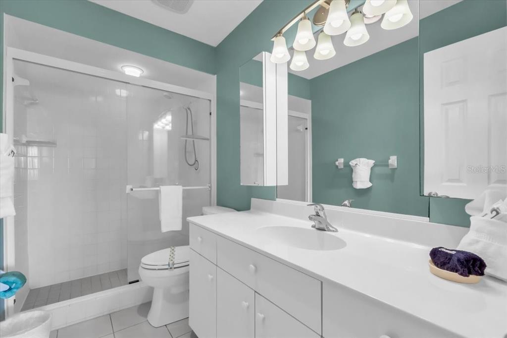 757 Beach Road, Unit 310 Sarasota, FL 34242 - Photo 14 of 31 a bathroom with a sink a toilet and a mirror