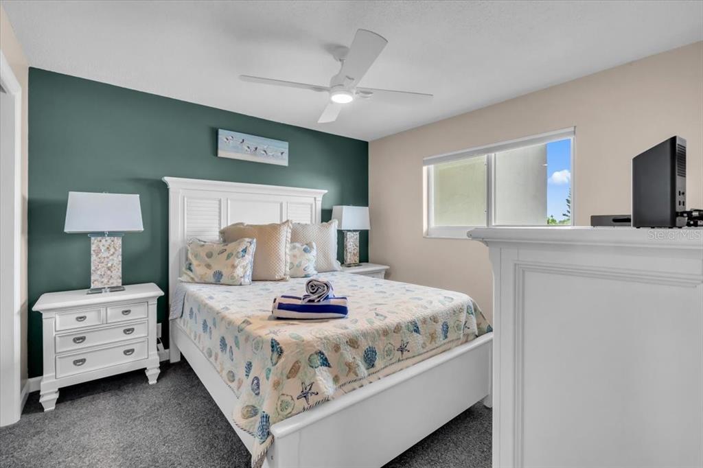 757 Beach Road, Unit 310 Sarasota, FL 34242 - Photo 15 of 31 a bedroom with a bed and furniture