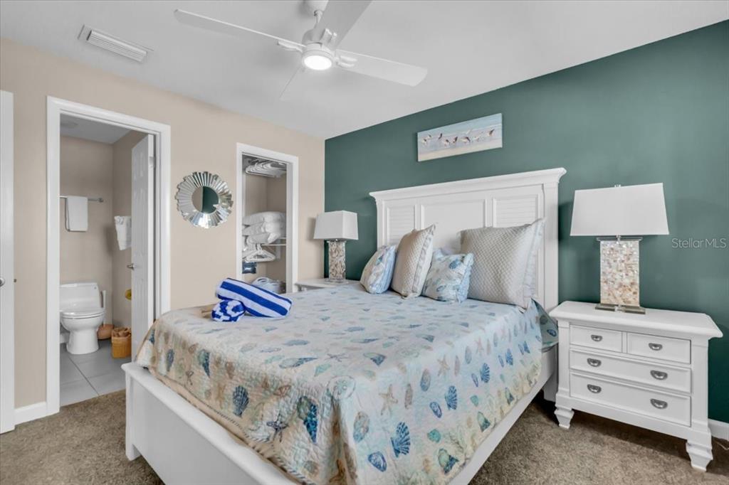 757 Beach Road, Unit 310 Sarasota, FL 34242 - Photo 16 of 31 a bedroom with a bed and a lamp on dresser