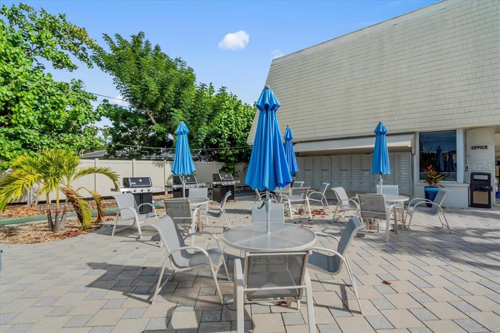 757 Beach Road, Unit 310 Sarasota, FL 34242 - Photo 25 of 31 a table and chairs sitting in front of a house