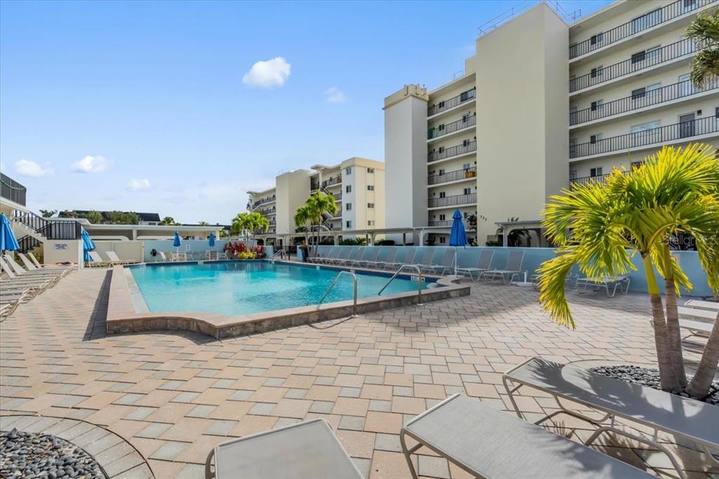 757 Beach Road, Unit 310 Sarasota, FL 34242 - Photo 26 of 31 a view of swimming pool with outdoor seating and plants