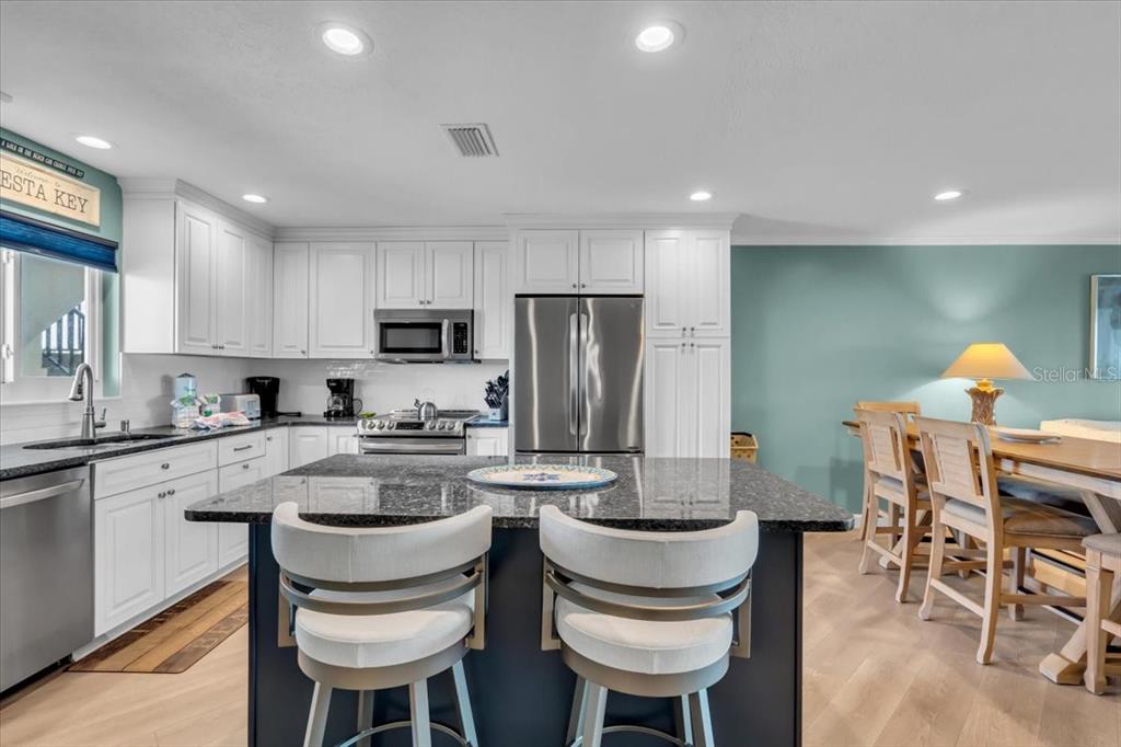 757 Beach Road, Unit 310 Sarasota, FL 34242 - Photo 10 of 31 a kitchen with a sink cabinets and stainless steel appliances