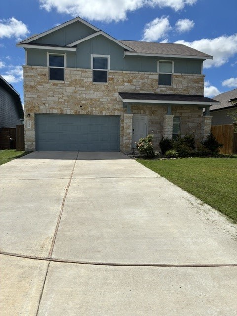 233 Perfect World Loop Jarrell, TX 76537 - Photo 3 of 24 A welcoming facade with a stone and siding exterior offers classic curb appeal.