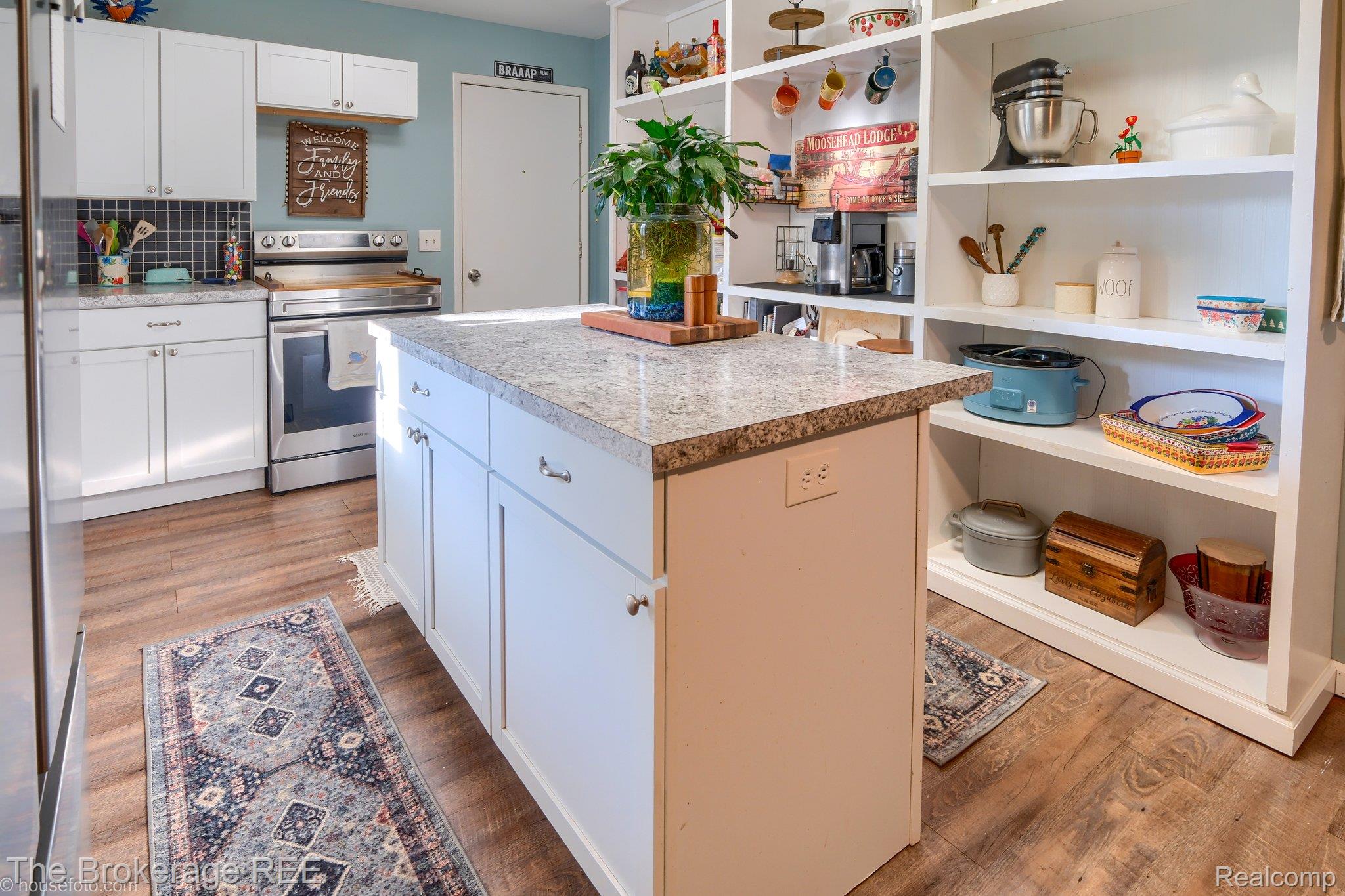 6288 Porter Road Grand Blanc, MI 48439 - Photo 15 of 39 Kitchen with a kitchen island, stainless steel electric range, white cabinetry, and light wood-style floors