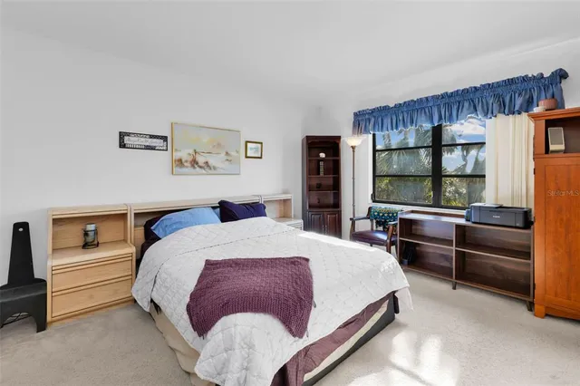 a bed room with a bed and a window