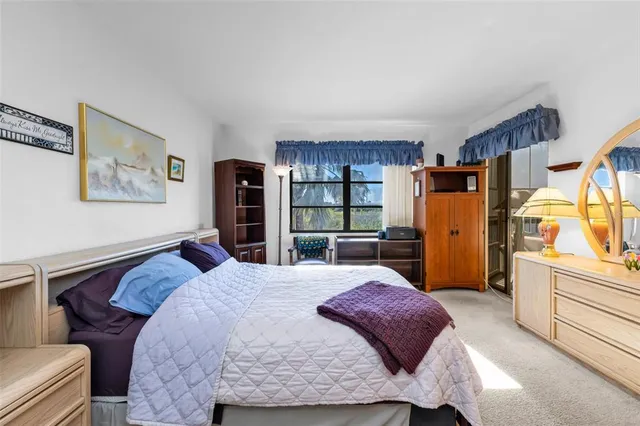 a bedroom with a bed and a cabinets