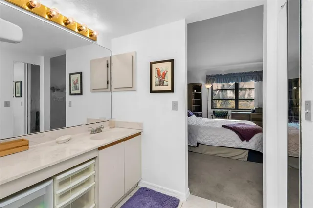 a en suite bathroom with a granite countertop sink