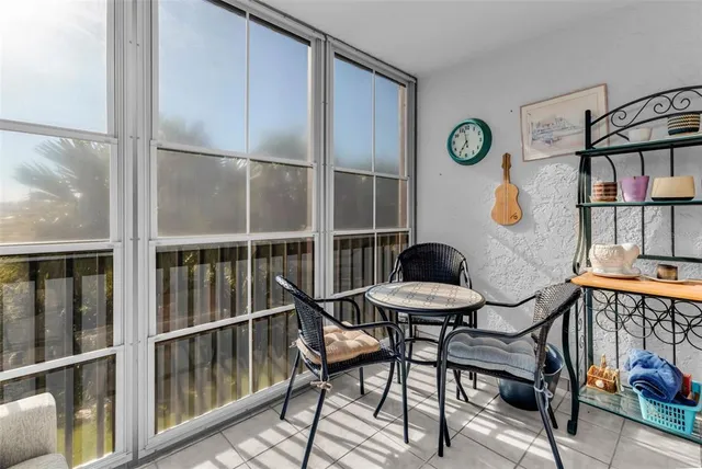 a view of a chairs and table in a balcony