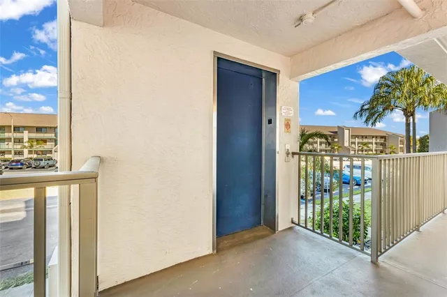 a view of a porch with a door and wooden fence