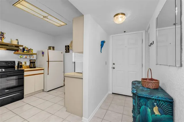 a kitchen with refrigerator and cabinets