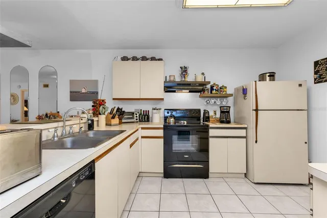 a kitchen with a refrigerator a stove and a sink