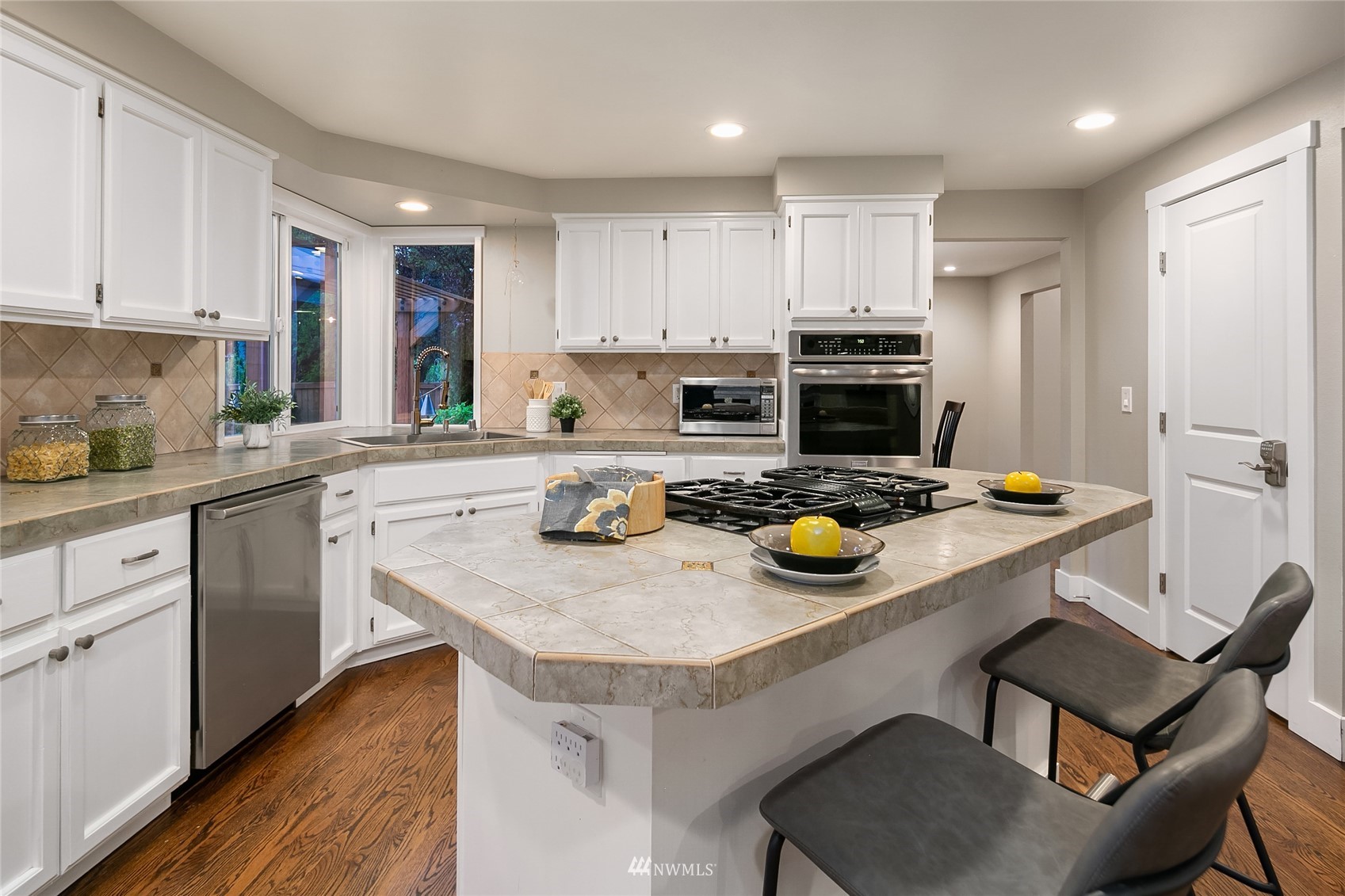 3228 211th Street Southeast Bothell, WA 98021 - Photo 11 of 40 a kitchen with a refrigerator a stove a sink and chairs