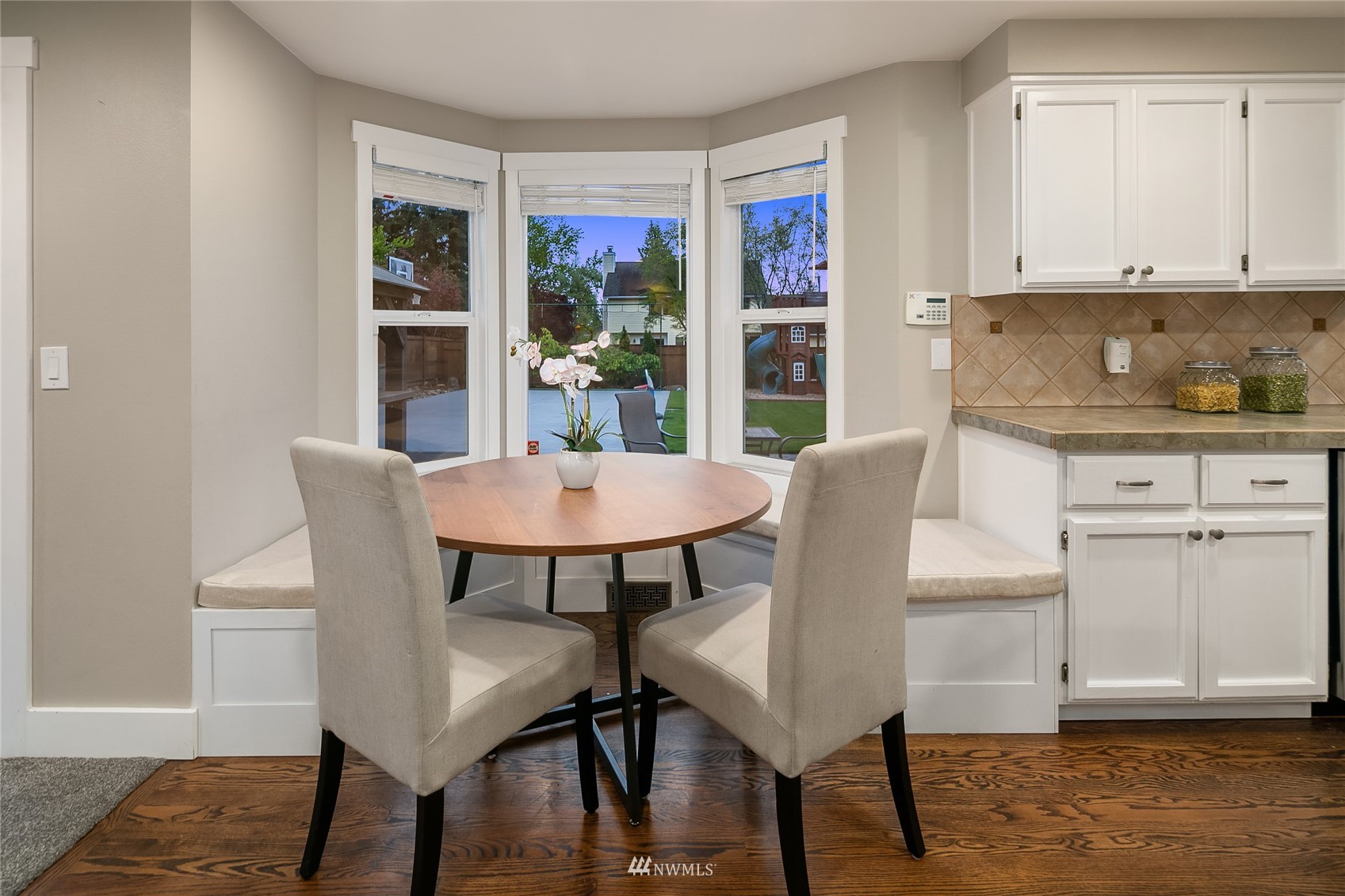 3228 211th Street Southeast Bothell, WA 98021 - Photo 12 of 40 a view of a dining room with furniture and wooden floor