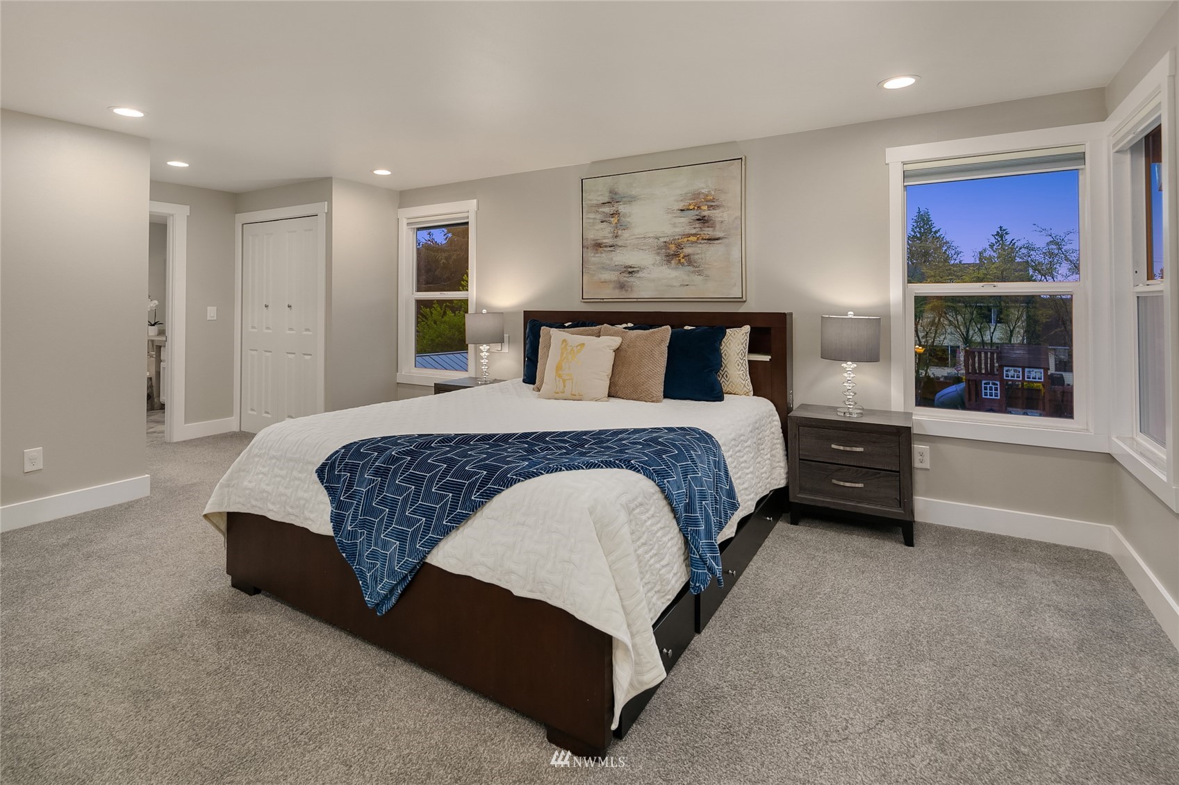 3228 211th Street Southeast Bothell, WA 98021 - Photo 17 of 40 a spacious bedroom with a bed and a painting on the wall