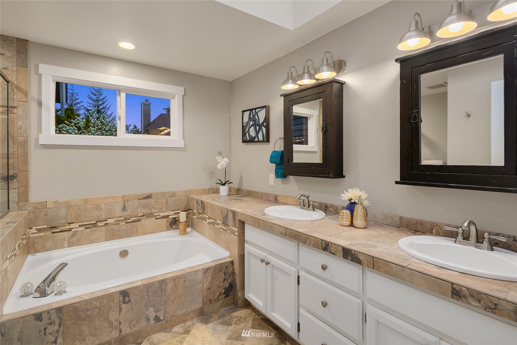 3228 211th Street Southeast Bothell, WA 98021 - Photo 19 of 40 a bathroom with a tub double sink and mirror