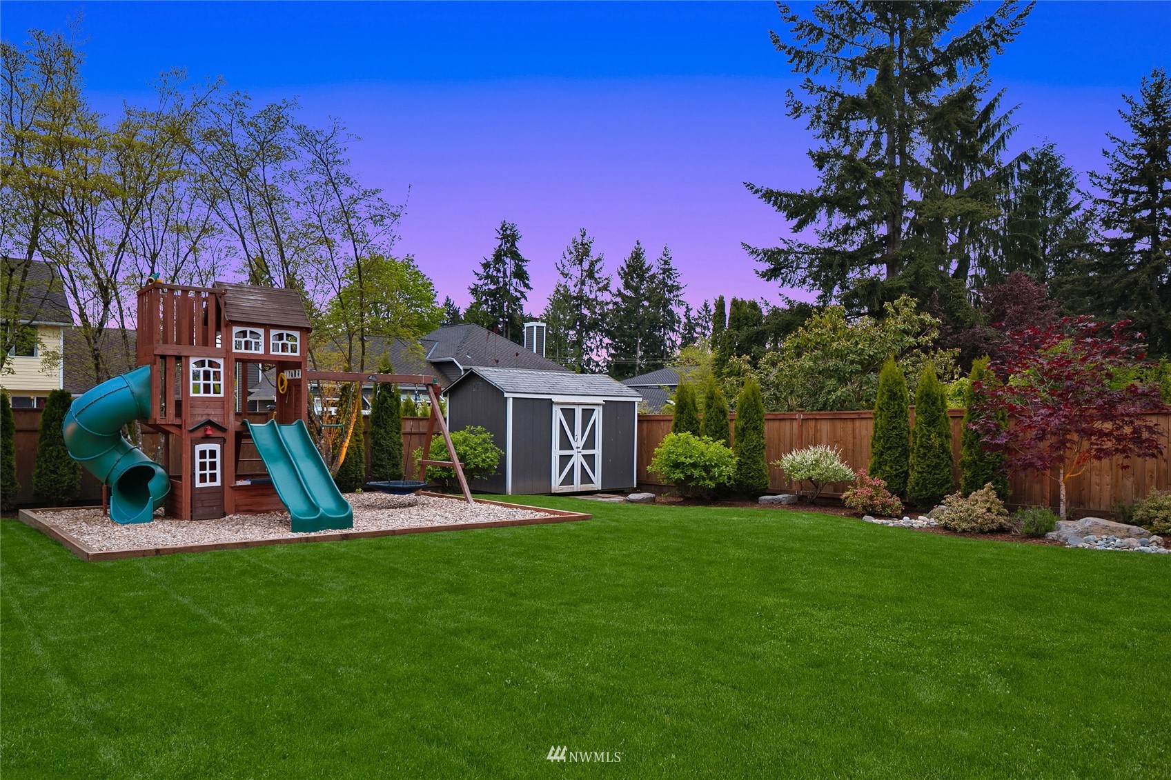 3228 211th Street Southeast Bothell, WA 98021 - Photo 35 of 40 a view of a house with a yard fire pit and a large tree