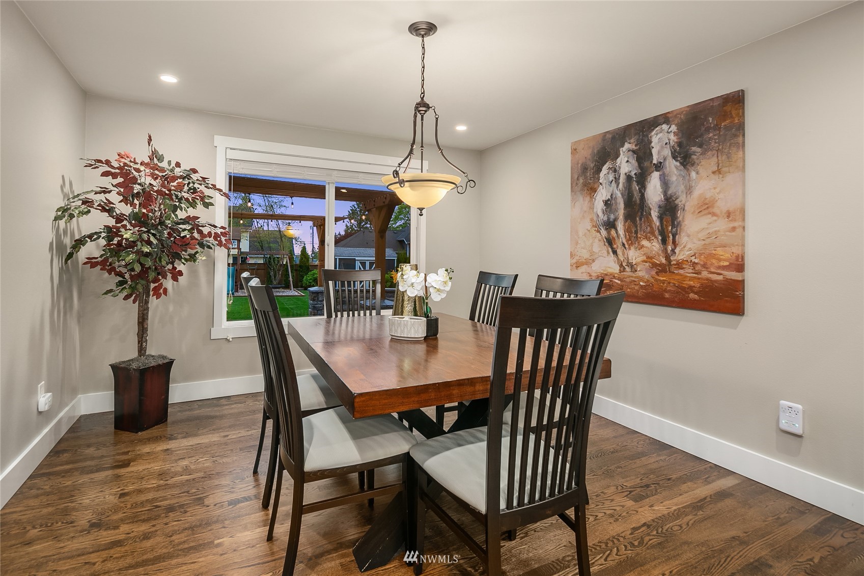 3228 211th Street Southeast Bothell, WA 98021 - Photo 7 of 40 a dining room with furniture potted plants and wooden floor