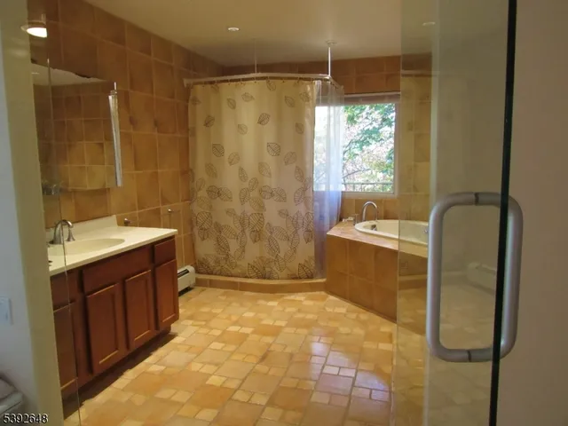 a bathroom with a glass shower door