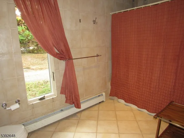 a spacious bedroom with a bed and large windows