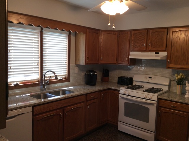 729 Rockhurst Road Bolingbrook, IL 60440 - Photo 6 of 20 a kitchen with granite countertop a sink a stove and cabinets