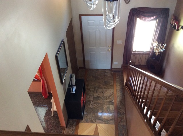 729 Rockhurst Road Bolingbrook, IL 60440 - Photo 9 of 20 a view of a hallway with wooden floor and stairs