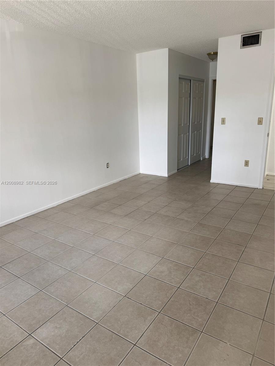 7747 Southwest 86th Street, Unit D105 Miami, FL 33143 - Photo 7 of 14 a view of an empty room