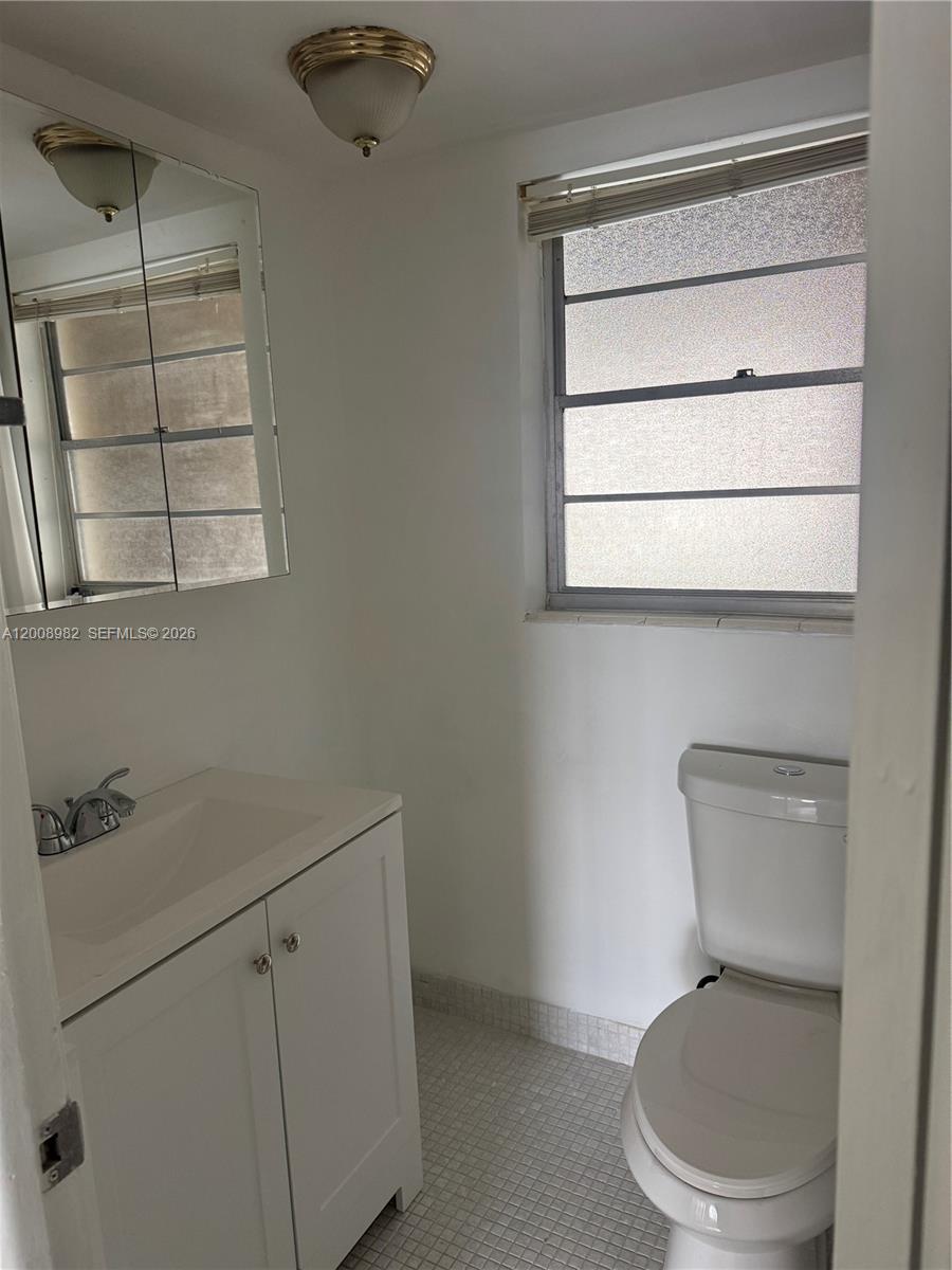 7747 Southwest 86th Street, Unit D105 Miami, FL 33143 - Photo 9 of 14 a white toilet sitting next to a bathroom sink