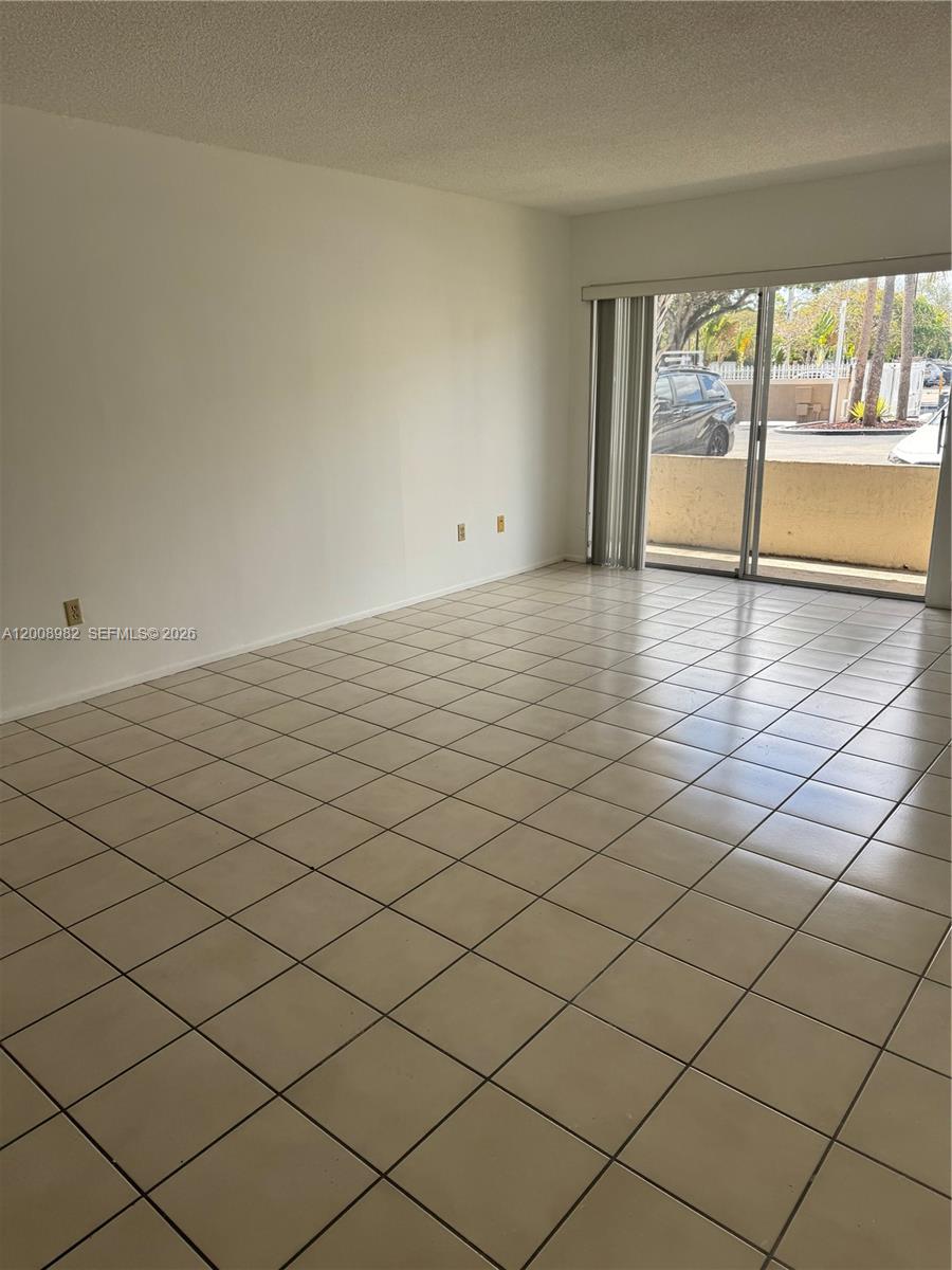7747 Southwest 86th Street, Unit D105 Miami, FL 33143 - Photo 10 of 14 a view of an empty room and window