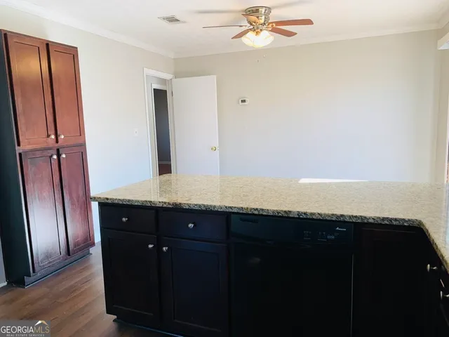 a bathroom with a granite countertop sink and mirror