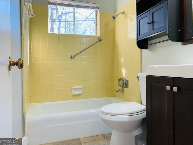 a bathroom with a sink a toilet and bathtub