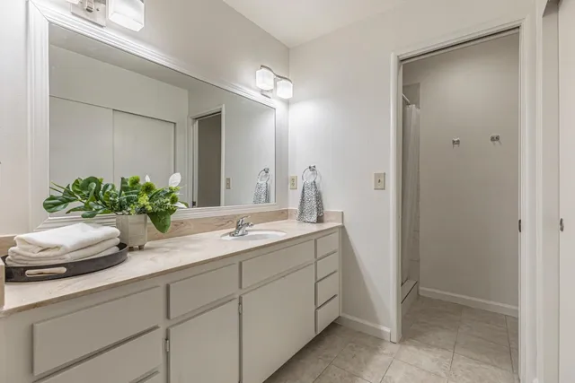 a living room with furniture a rug a lamp and a window