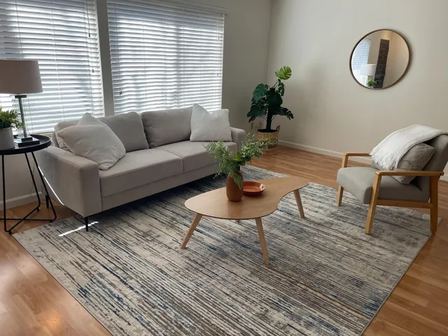 a spacious bedroom with a bed and a chair