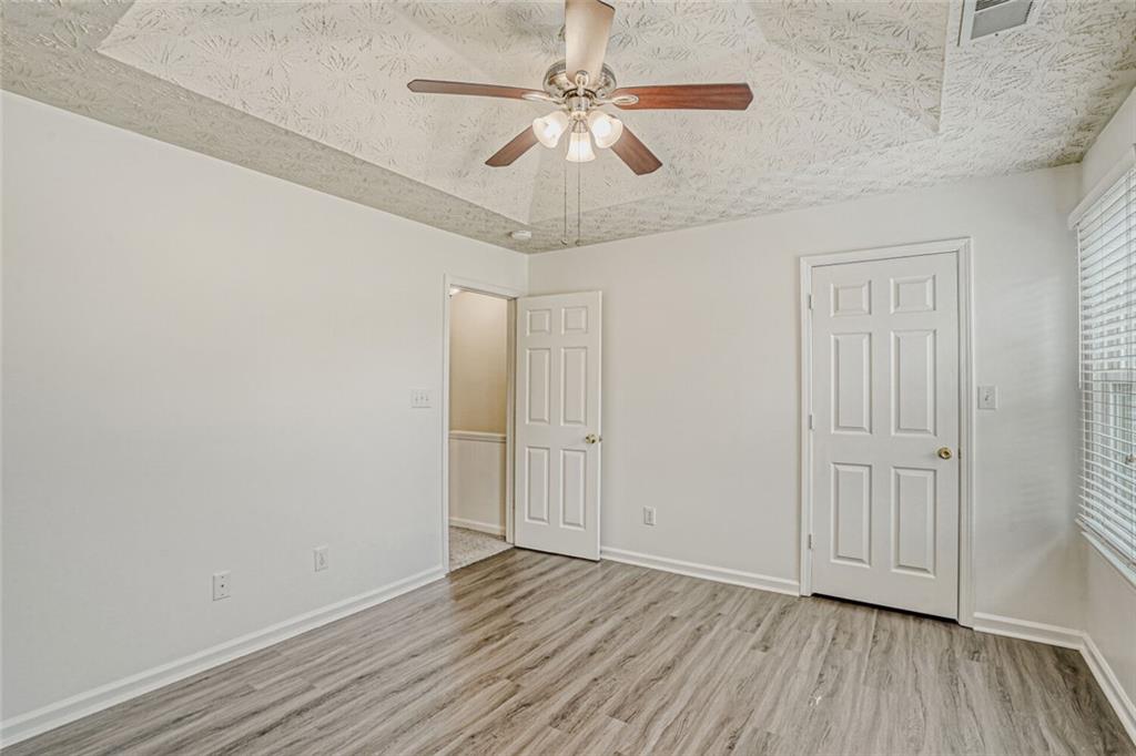 4120 Spring Cove Drive Duluth, GA 30097 - Photo 12 of 24 wooden floor in an empty room with a window