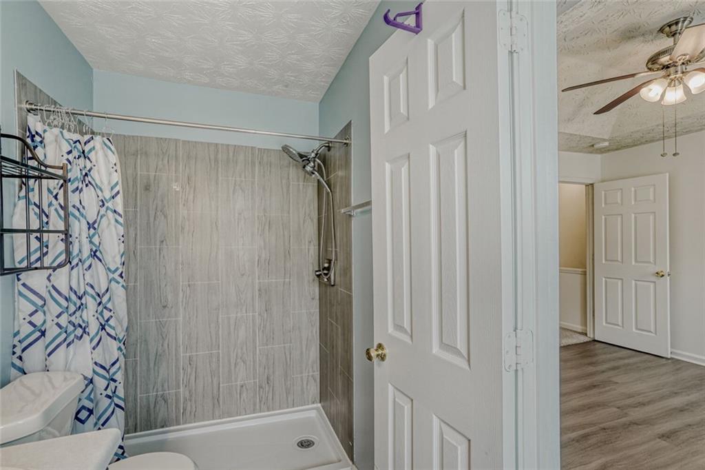 4120 Spring Cove Drive Duluth, GA 30097 - Photo 13 of 24 a bathroom with a shower and a sink