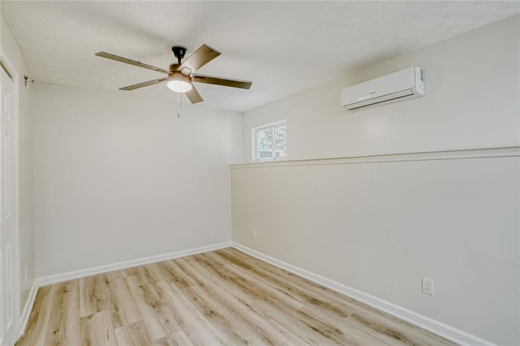 4120 Spring Cove Drive Duluth, GA 30097 - Photo 16 of 24 a view of a room with wooden floor and ceiling fan