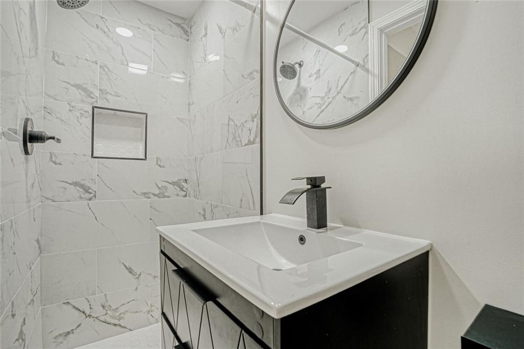 4120 Spring Cove Drive Duluth, GA 30097 - Photo 19 of 24 a bathroom with a sink a vanity and a mirror