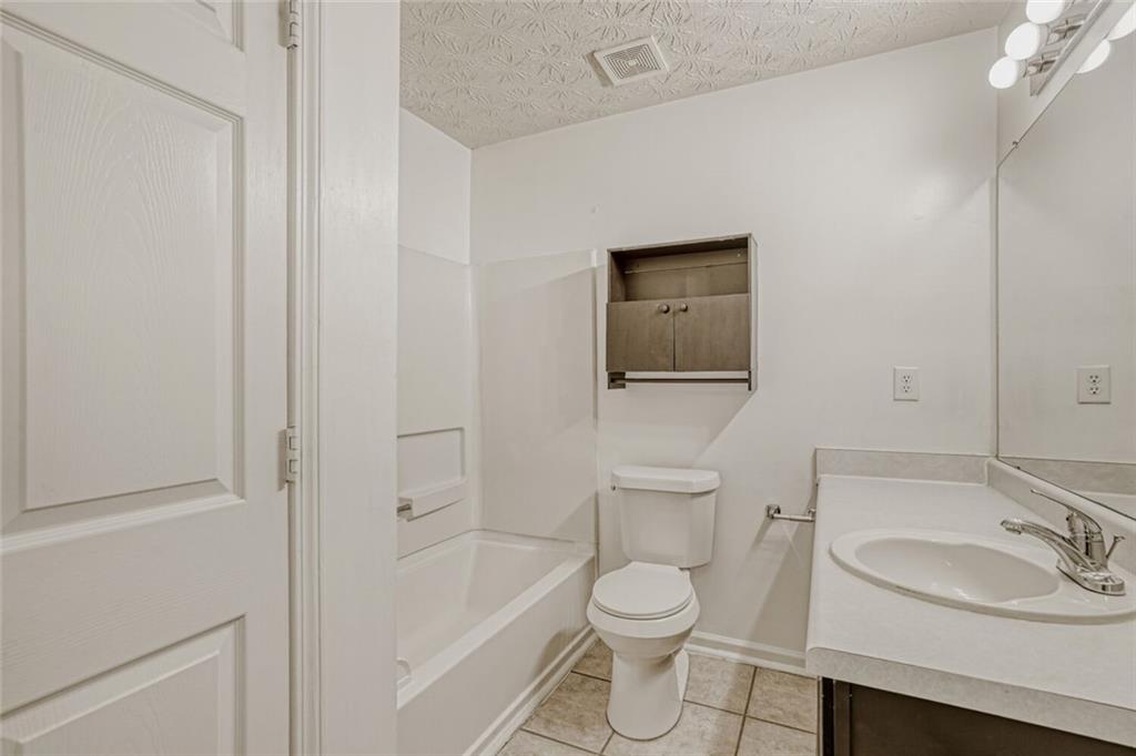 4120 Spring Cove Drive Duluth, GA 30097 - Photo 20 of 24 a bathroom with a toilet a sink and bathtub