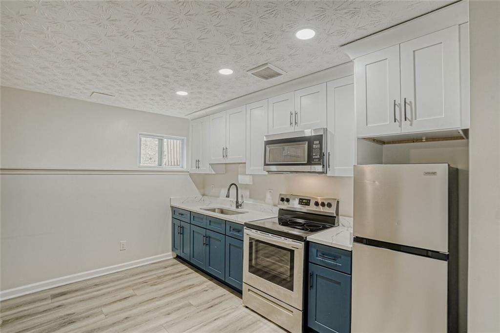 4120 Spring Cove Drive Duluth, GA 30097 - Photo 6 of 24 a kitchen with stainless steel appliances granite countertop a refrigerator sink and stove