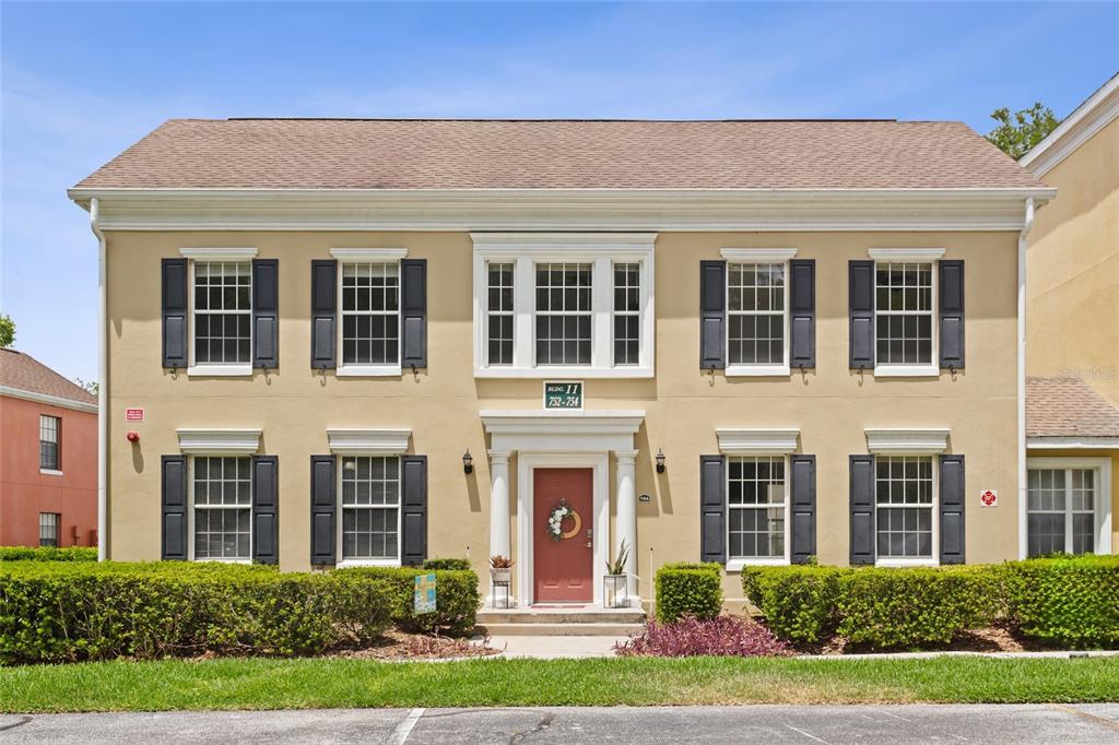 front view of a brick building with a yard