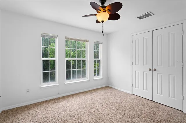 a view of room and chandelier fan
