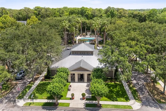a room with a black white checkered floor with a dining table and chair