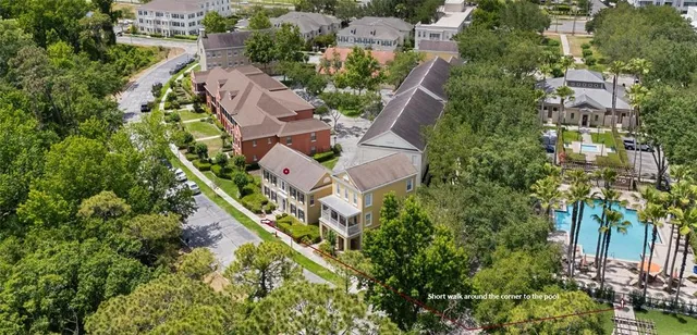 an aerial view of residential houses with outdoor space and river