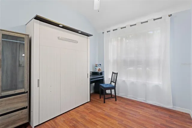 a view of bathroom with a shower and closet