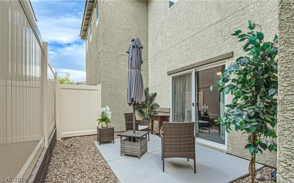 12110 Midnight Pine Road, Unit 3 Las Vegas, NV 89183 - Photo 9 of 13 Enjoy quiet outdoor moments on this private patio with robust fencing and ample relaxation space.