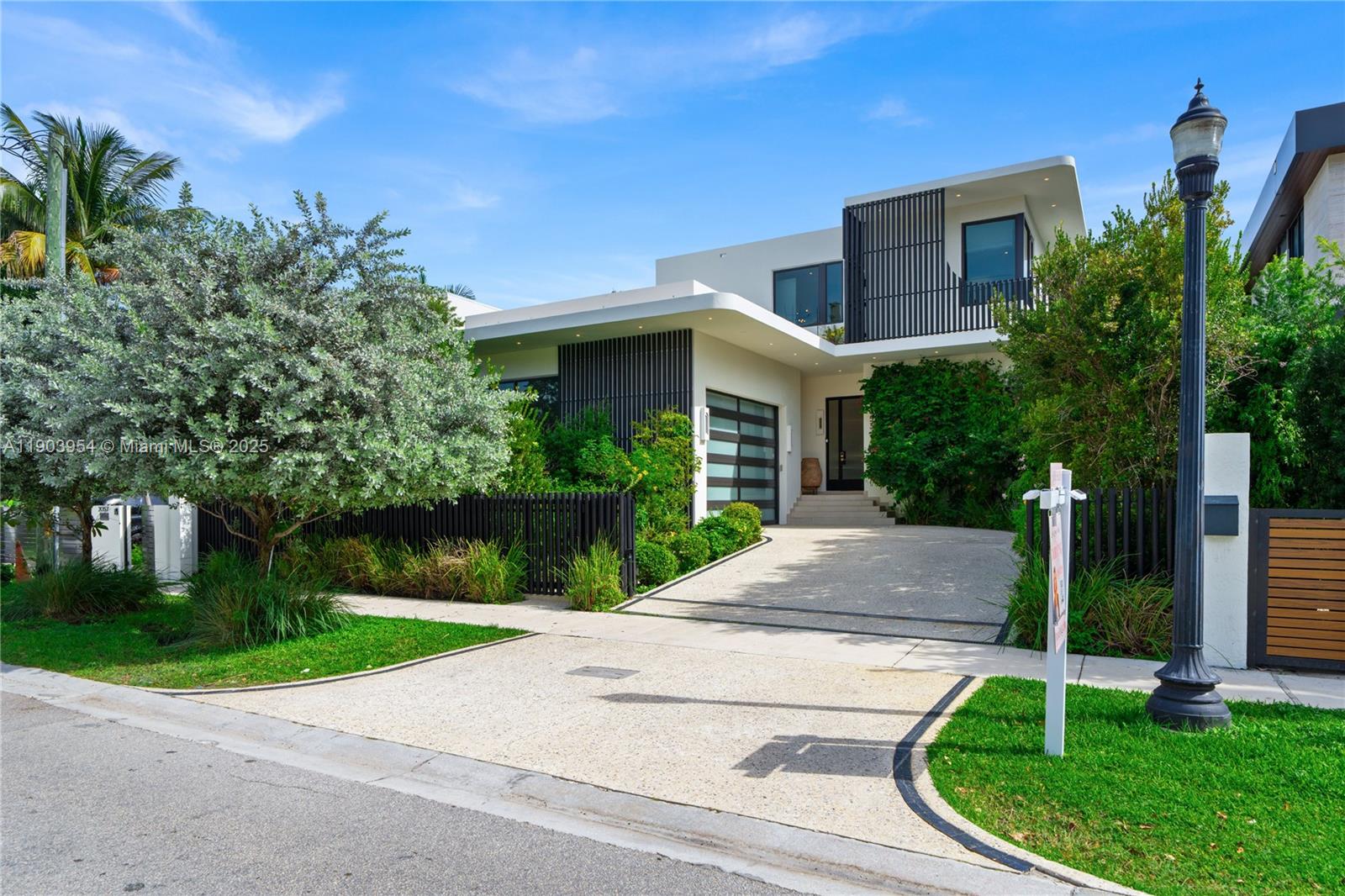 2053 North Bay Road Miami Beach, FL 33140 - Photo 25 of 99 a front view of a house with a yard
