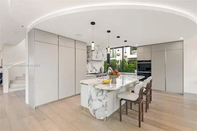 a view of a patio with table and chairs and potted plants with wooden floor and fence