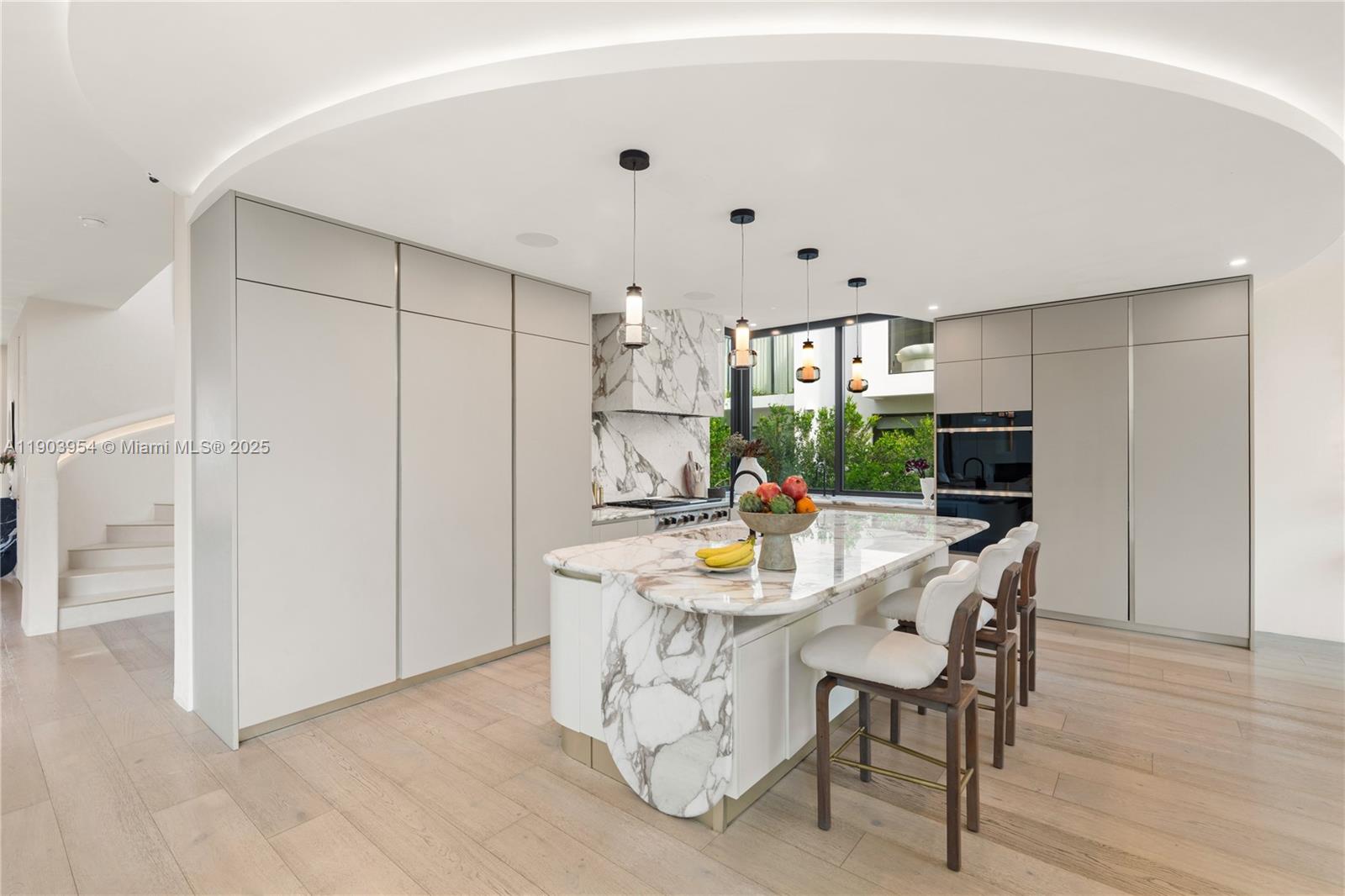 2053 North Bay Road Miami Beach, FL 33140 - Photo 31 of 99 a kitchen with stainless steel appliances granite countertop a refrigerator and a stove top oven