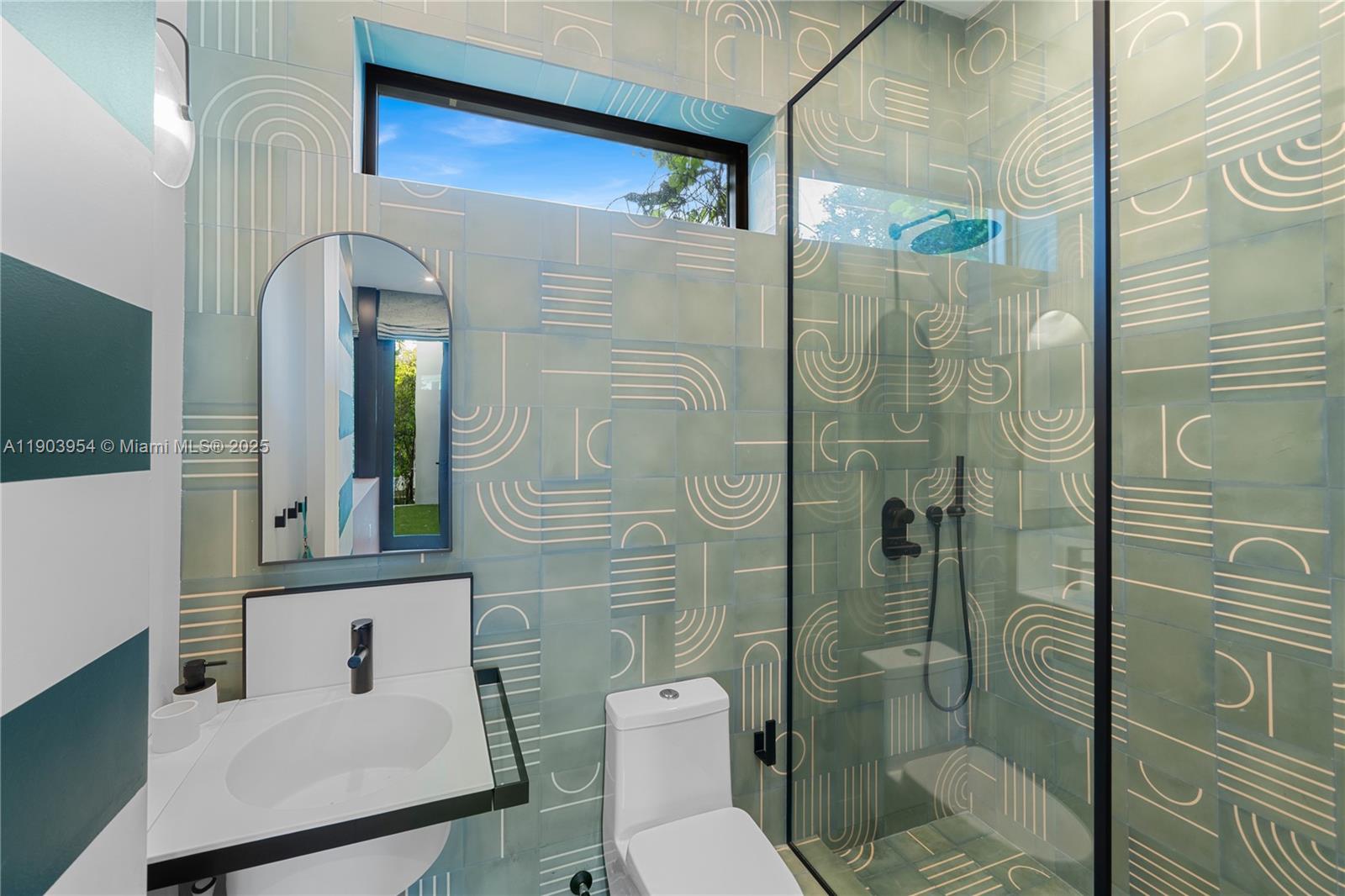 2053 North Bay Road Miami Beach, FL 33140 - Photo 38 of 99 a bathroom with a toilet a sink and shower