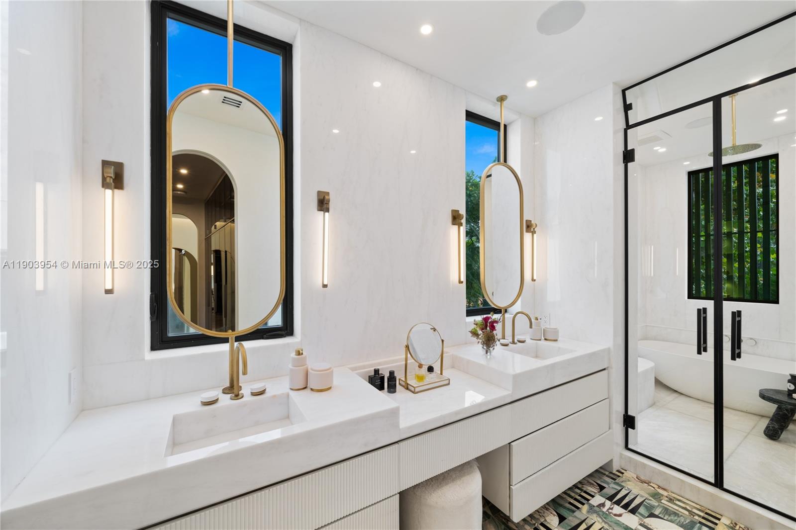 2053 North Bay Road Miami Beach, FL 33140 - Photo 47 of 99 a bathroom with a double vanity sink and a mirror