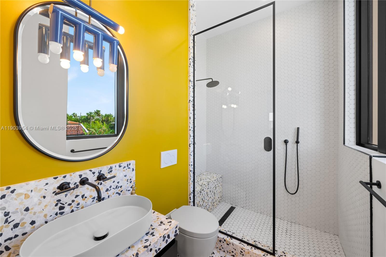 2053 North Bay Road Miami Beach, FL 33140 - Photo 58 of 99 a bathroom with a sink and mirror with toilet